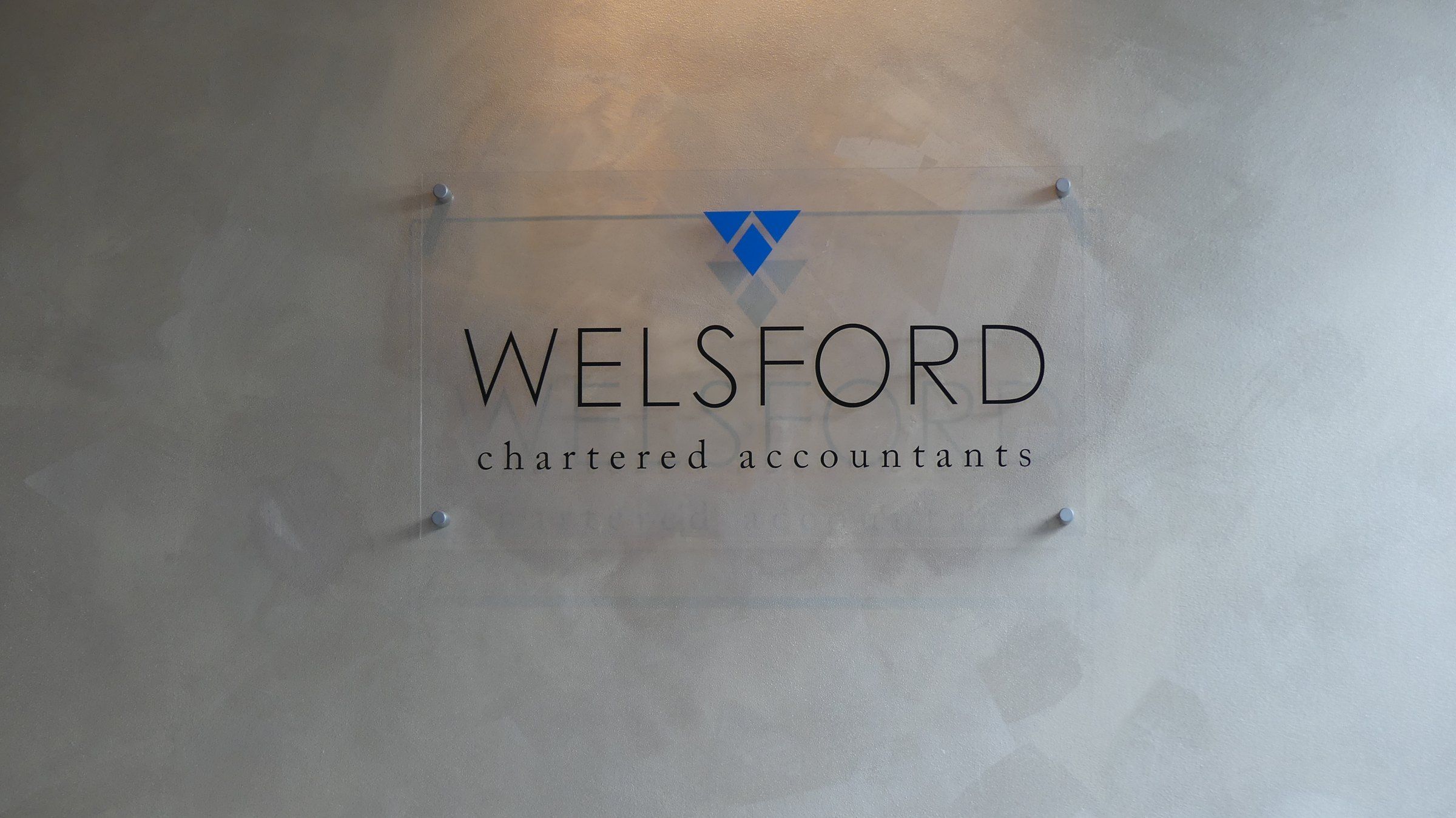 The Welsford Chartered Accountants sign on the wall of their office
